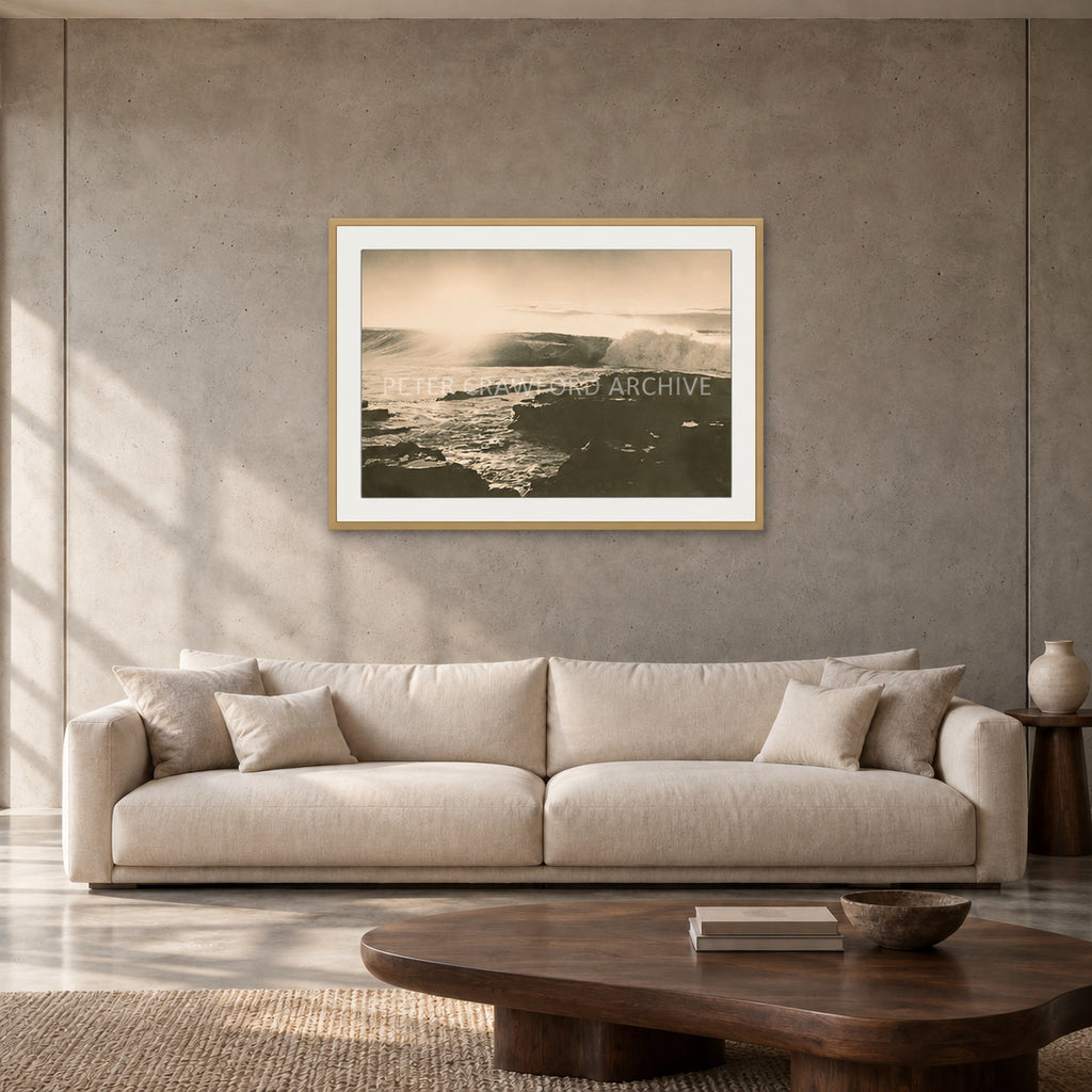 Peter Crawford Barrel at Dee Why — 90 × 60 cm, hayseed frame with mat, shown in a contemporary concrete-wall living room.
