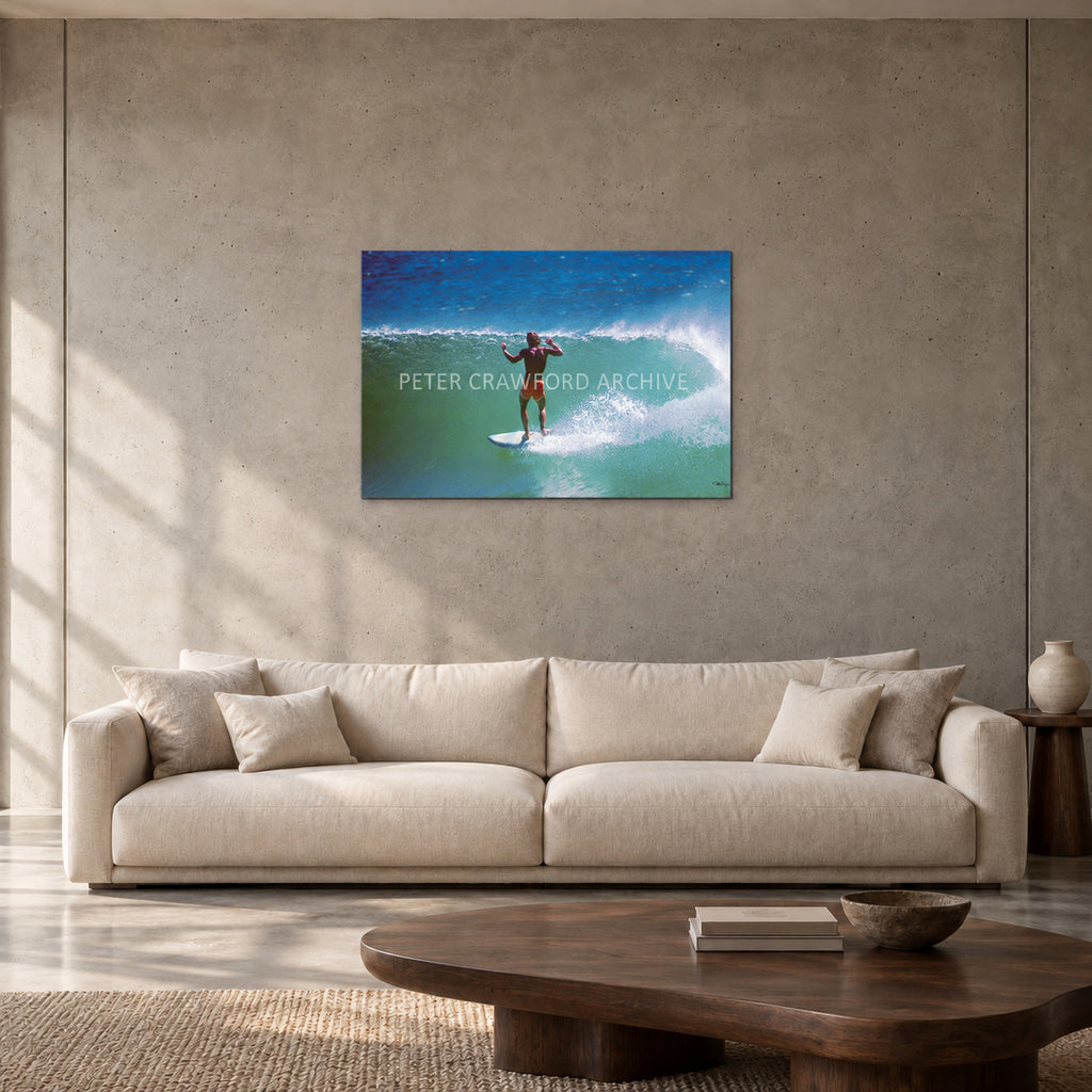 Terry Fitzgerald at Sunset Beach — 90 × 60 cm, aluminium resin mount, shown in a contemporary concrete-wall living room.