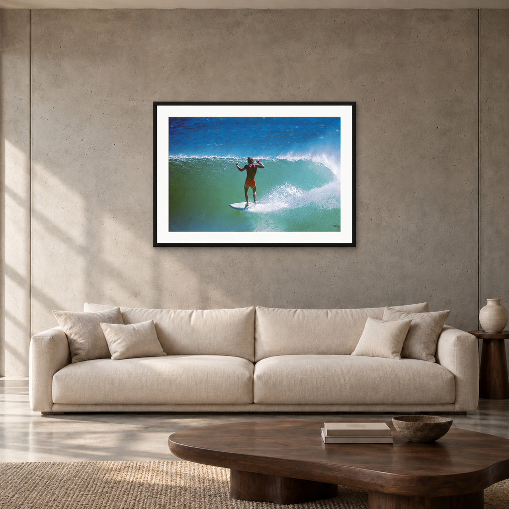 Terry Fitzgerald at Sunset Beach — 90 × 60 cm, black frame with mat, shown in a contemporary concrete-wall living room.