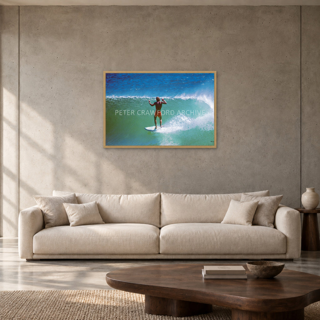 Terry Fitzgerald at Sunset Beach — 90 × 60 cm, hayseed full frame, shown in a contemporary concrete-wall living room.