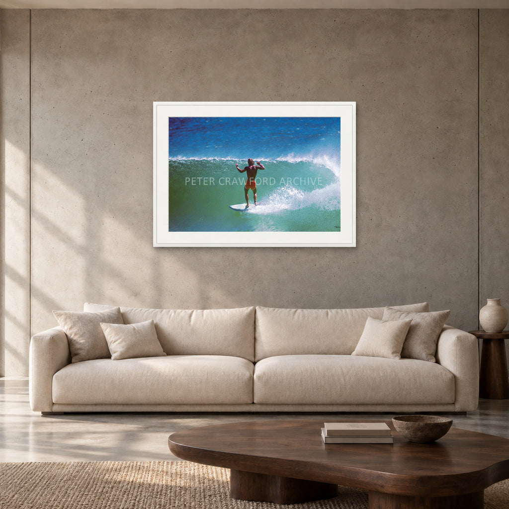 Terry Fitzgerald at Sunset Beach — 90 × 60 cm, white frame with mat, shown in a contemporary concrete-wall living room.