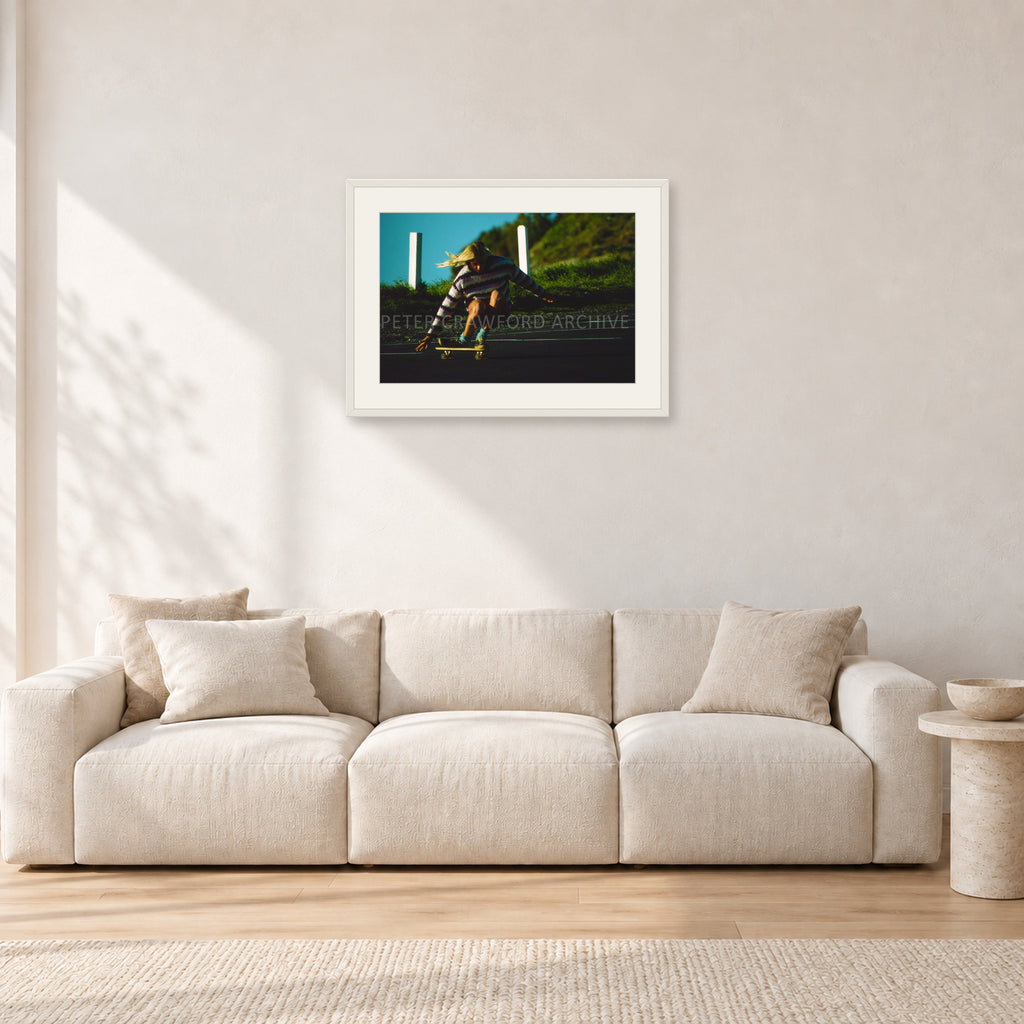 Russel Lewis Skate DY by Peter Crawford — 60 × 40 cm, white frame with white mat, shown in a light minimalist living room.