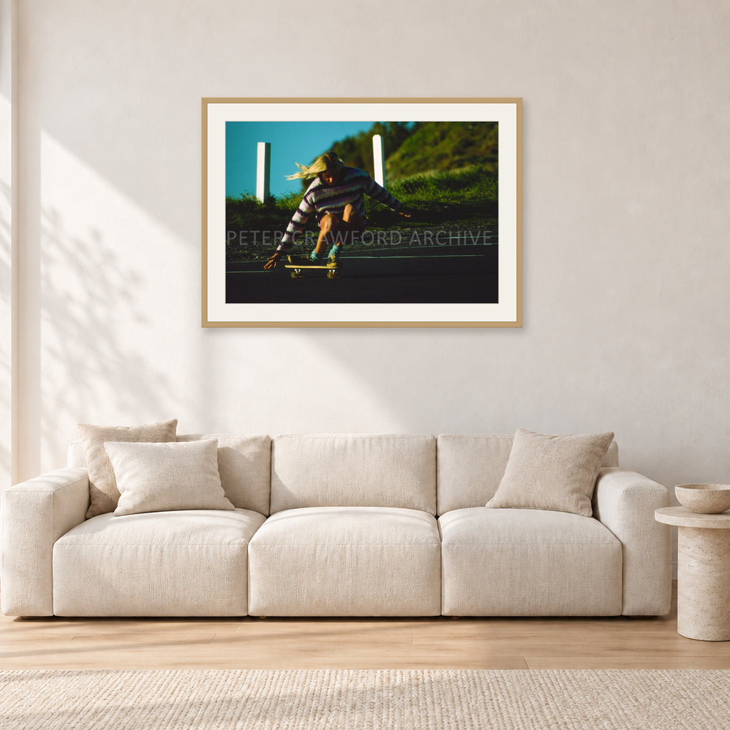 Russel Lewis Skate DY by Peter Crawford — 90 × 60 cm, hayseed frame with white mat, shown in a light minimalist living room.