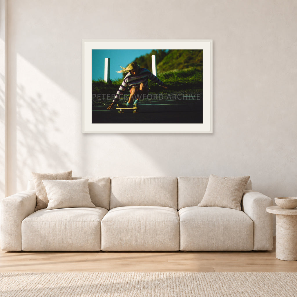 Russel Lewis Skate DY by Peter Crawford — 90 × 60 cm, white frame with white mat, shown in a light minimalist living room.