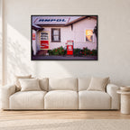 Seventies Petrol Station, 1970 by Peter Crawford — 120 × 80 cm, black frame, shown in a light minimalist living room.