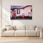 Seventies Petrol Station, 1970 by Peter Crawford — 120 × 80 cm, white frame, shown in a light minimalist living room.