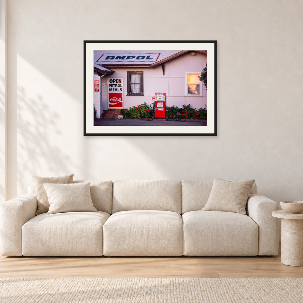 Seventies Petrol Station, 1970 by Peter Crawford — 90 × 60 cm, black frame with white mat, shown in a light minimalist living room.