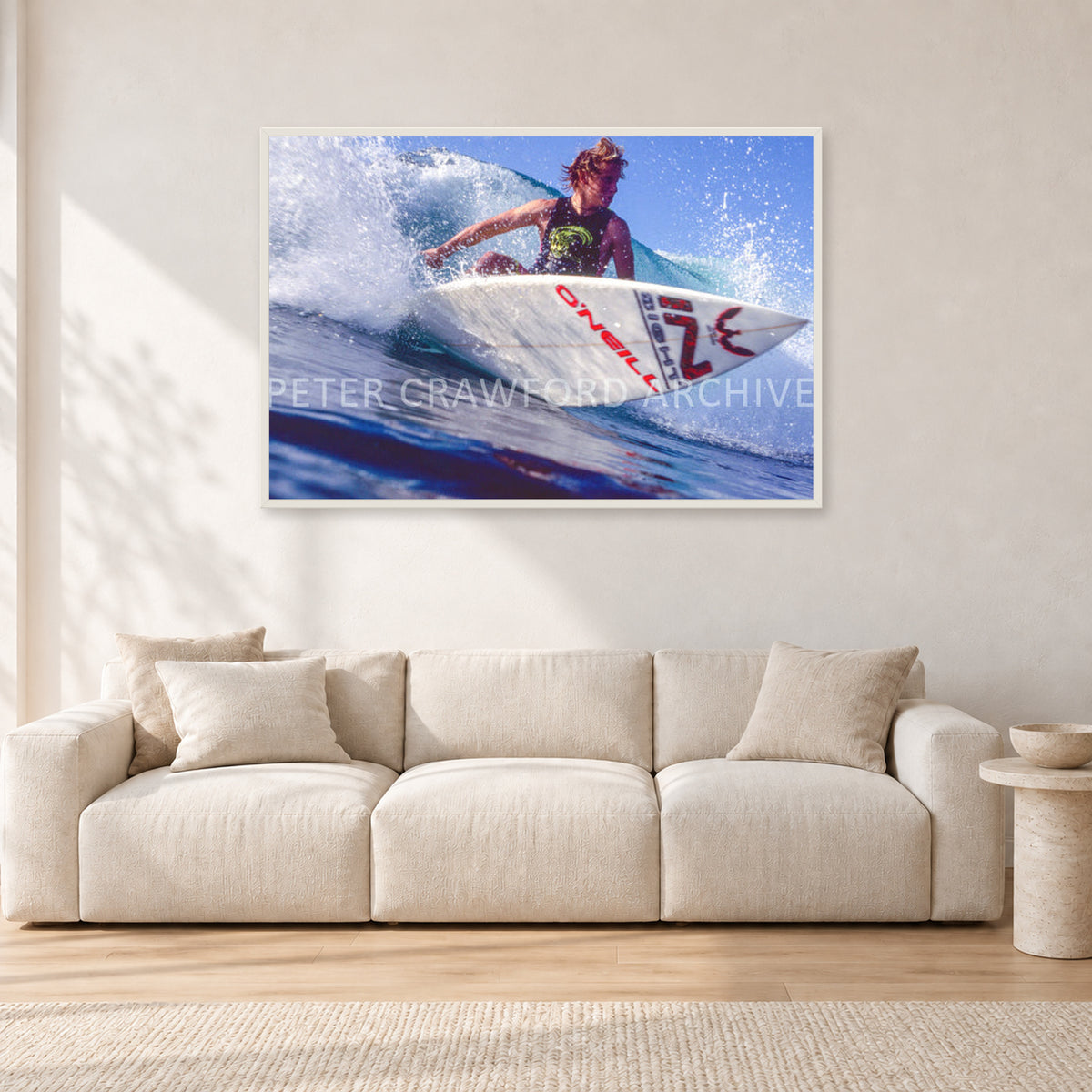 Shane Herring, Dee Why Point 1989 by Peter Crawford — 120 × 80 cm, white frame, shown in a light minimalist living room.