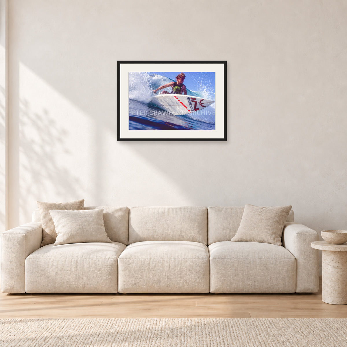 Shane Herring, Dee Why Point 1989 by Peter Crawford — 60 × 40 cm, black frame with white mat, shown in a light minimalist living room.