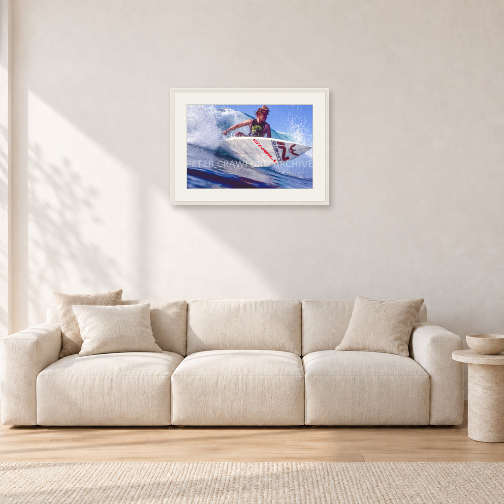 Shane Herring, Dee Why Point 1989 by Peter Crawford — 60 × 40 cm, white frame with white mat, shown in a light minimalist living room.