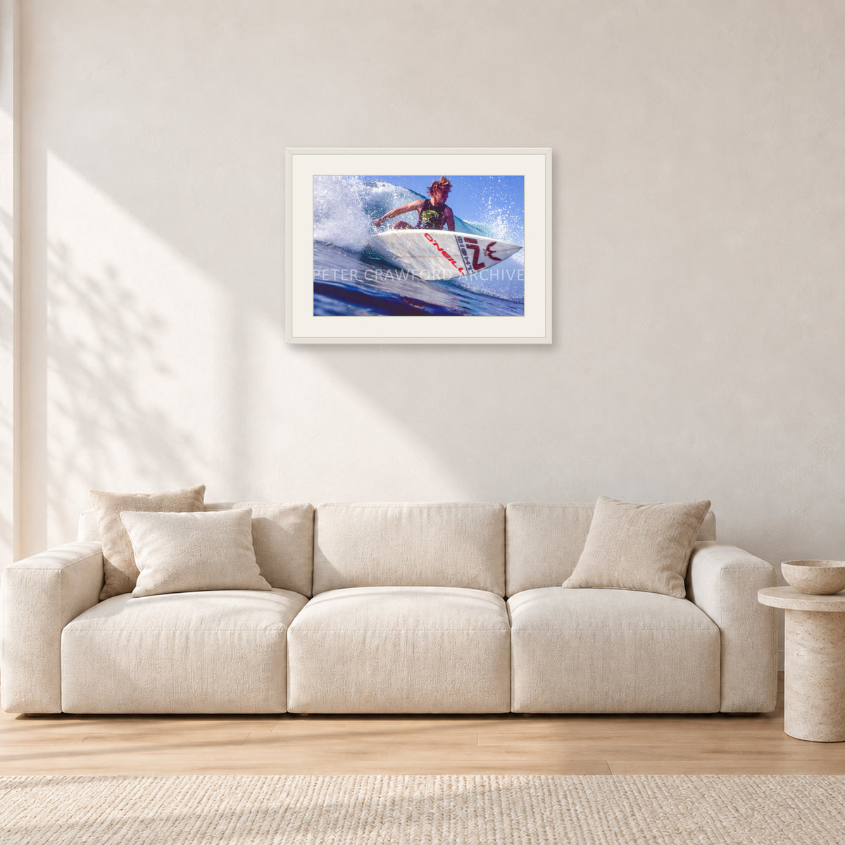 Shane Herring, Dee Why Point 1989 by Peter Crawford — 60 × 40 cm, white frame with white mat, shown in a light minimalist living room.