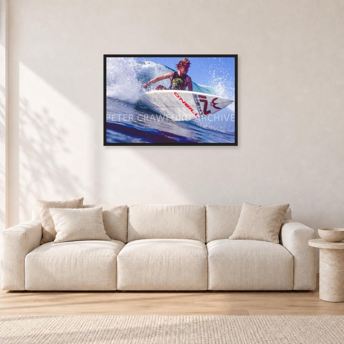 Shane Herring, Dee Why Point 1989 by Peter Crawford — 90 × 60 cm, black frame, shown in a light minimalist living room.