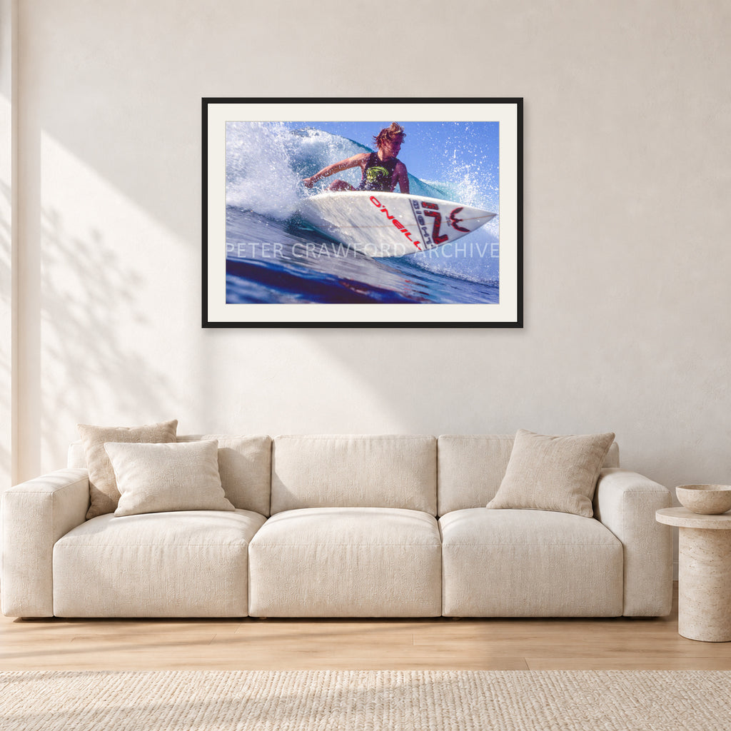 Shane Herring, Dee Why Point 1989 by Peter Crawford — 90 × 60 cm, black frame with white mat, shown in a light minimalist living room.