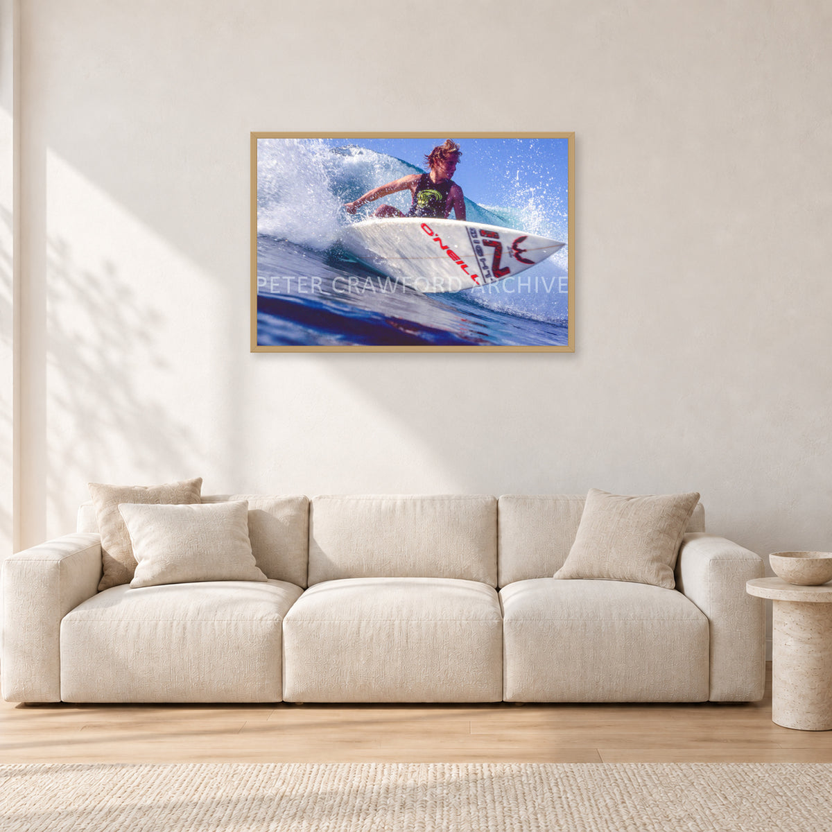 Shane Herring, Dee Why Point 1989 by Peter Crawford — 90 × 60 cm, hayseed frame, shown in a light minimalist living room.