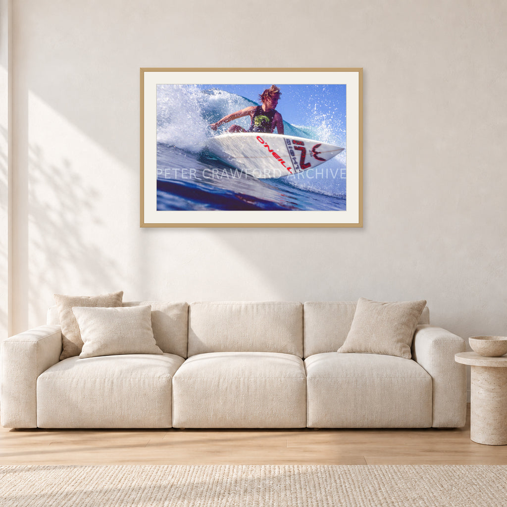 Shane Herring, Dee Why Point 1989 by Peter Crawford — 90 × 60 cm, hayseed frame with white mat, shown in a light minimalist living room.