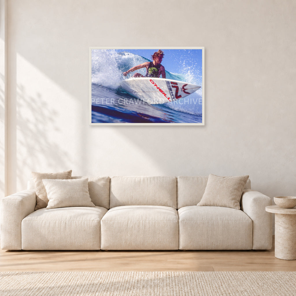 Shane Herring, Dee Why Point 1989 by Peter Crawford — 90 × 60 cm, white frame, shown in a light minimalist living room.