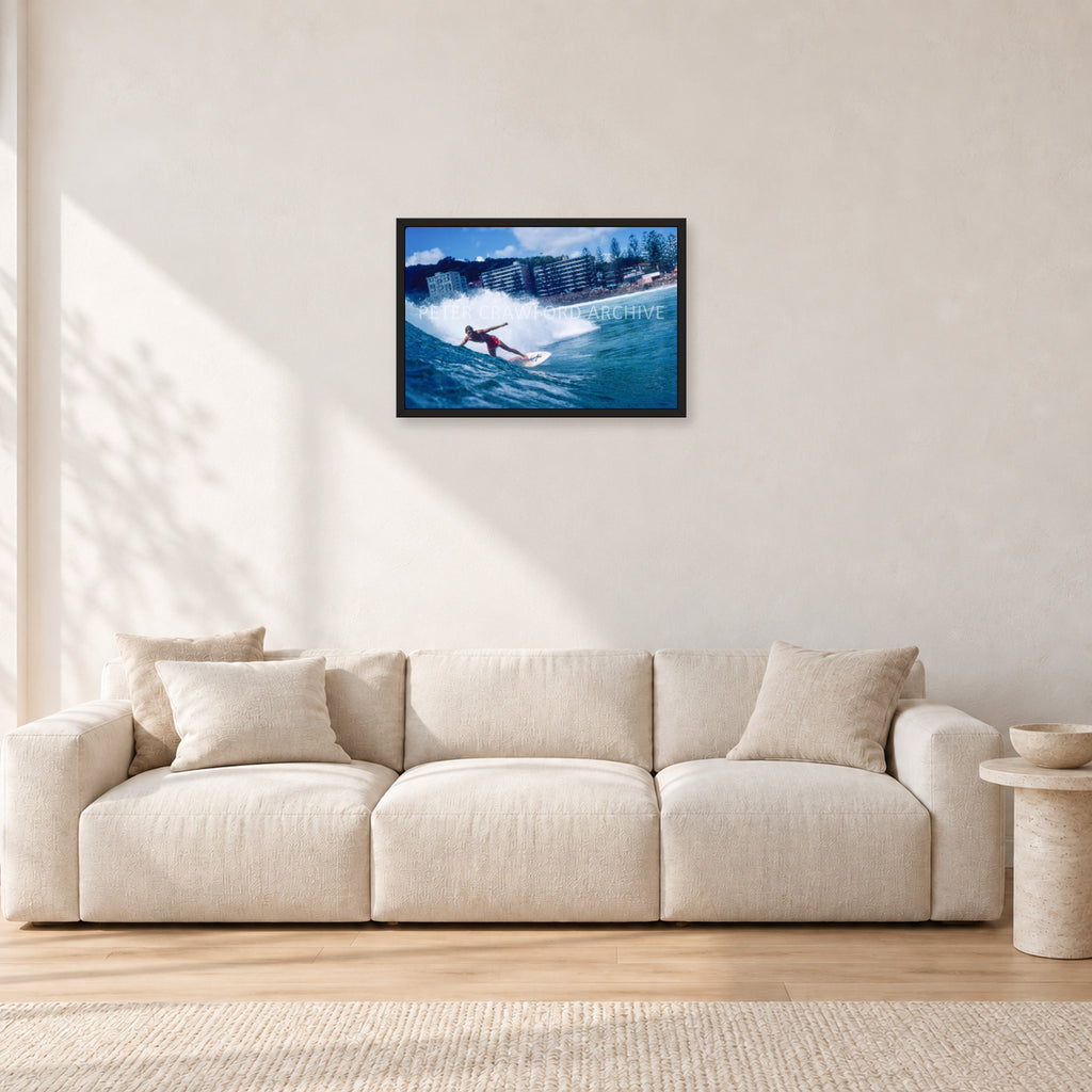 Shaun, Stubbies 1977 by Peter Crawford — 60 × 40 cm, black frame, shown in a light minimalist living room.