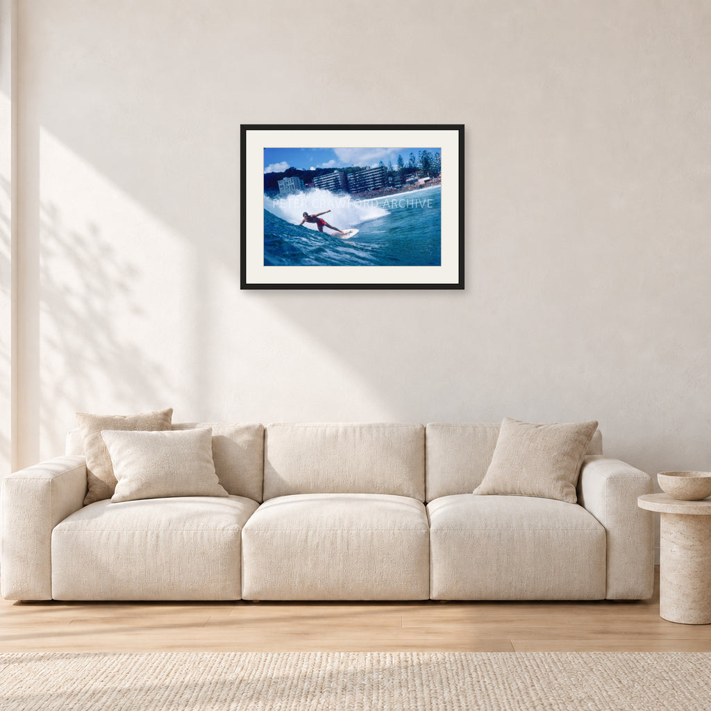 Shaun, Stubbies 1977 by Peter Crawford — 60 × 40 cm, black frame with white mat, shown in a light minimalist living room.