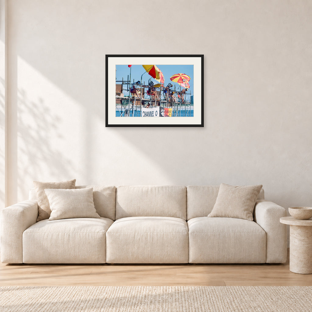 Stubbies Judges 1980 by Peter Crawford — 60 × 40 cm, black frame with white mat, shown in a light minimalist living room.