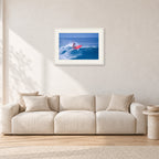 Sunset Beach, Hawaii by Peter Crawford — 60 × 40 cm, white frame with white mat, shown in a light minimalist living room.