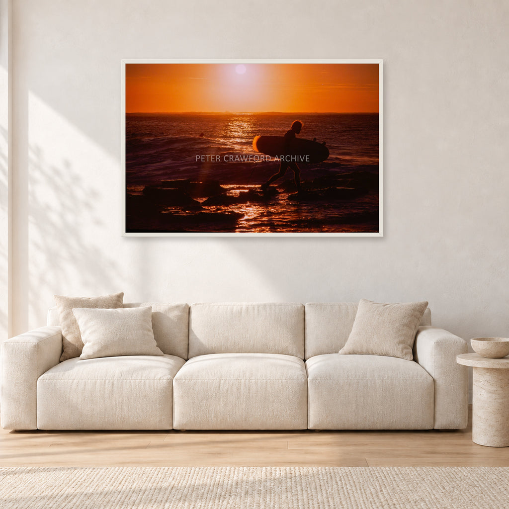 Sunset X1 by Peter Crawford — 120 × 80 cm, white frame, shown in a light minimalist living room.