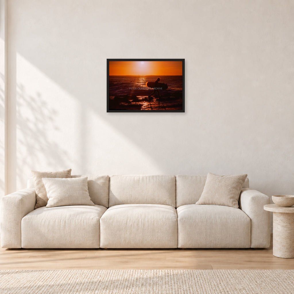 Sunset X1 by Peter Crawford — 60 × 40 cm, black frame, shown in a light minimalist living room.