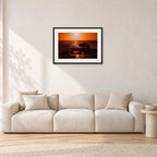 Sunset X1 by Peter Crawford — 60 × 40 cm, black frame with white mat, shown in a light minimalist living room.
