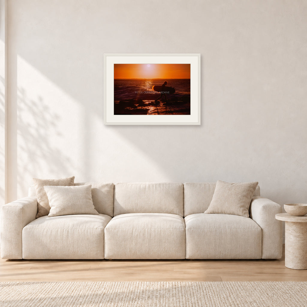 Sunset X1 by Peter Crawford — 60 × 40 cm, white frame with white mat, shown in a light minimalist living room.