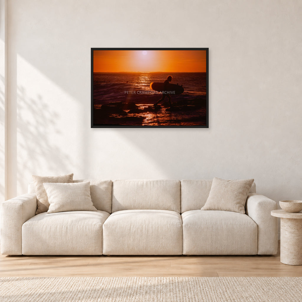 Sunset X1 by Peter Crawford — 90 × 60 cm, black frame, shown in a light minimalist living room.