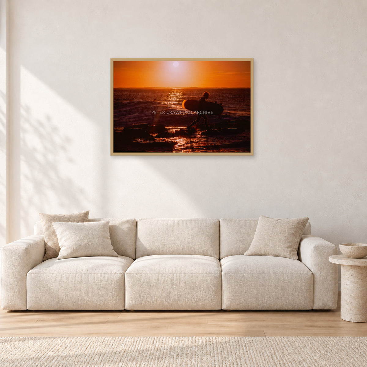 Sunset X1 by Peter Crawford — 90 × 60 cm, hayseed frame, shown in a light minimalist living room.