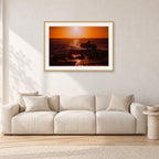 Sunset X1 by Peter Crawford — 90 × 60 cm, hayseed frame with white mat, shown in a light minimalist living room.