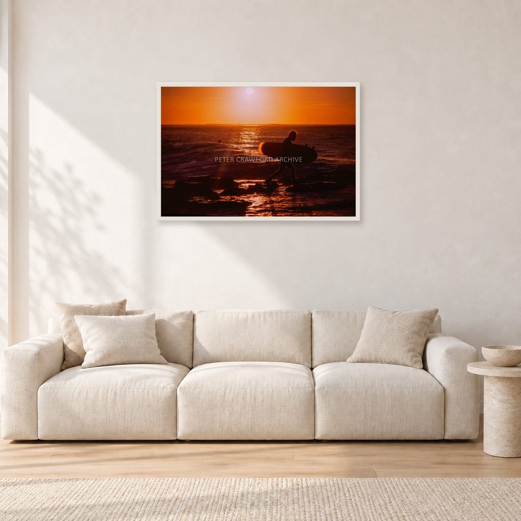 Sunset X1 by Peter Crawford — 90 × 60 cm, white frame, shown in a light minimalist living room.