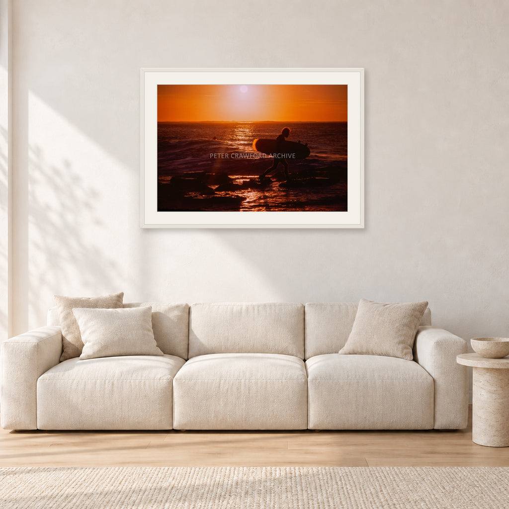Sunset X1 by Peter Crawford — 90 × 60 cm, white frame with white mat, shown in a light minimalist living room.