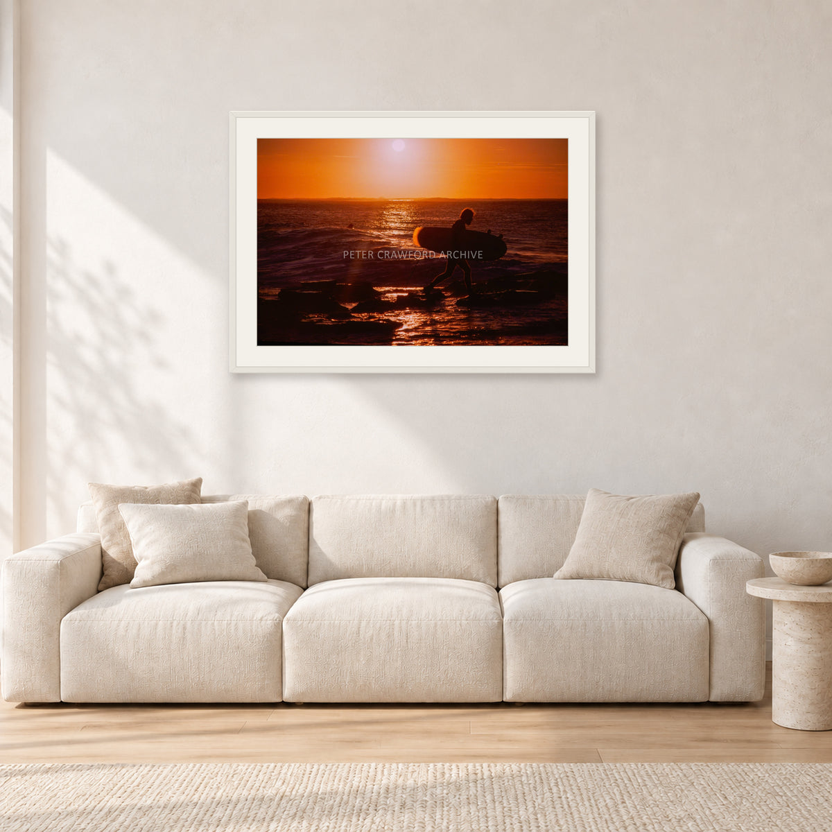 Sunset X1 by Peter Crawford — 90 × 60 cm, white frame with white mat, shown in a light minimalist living room.