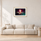 Tom Carroll and Aaron Chang, Waimea 1985 by Peter Crawford — 60 × 40 cm, hayseed frame with white mat, shown in a light minimalist living room.
