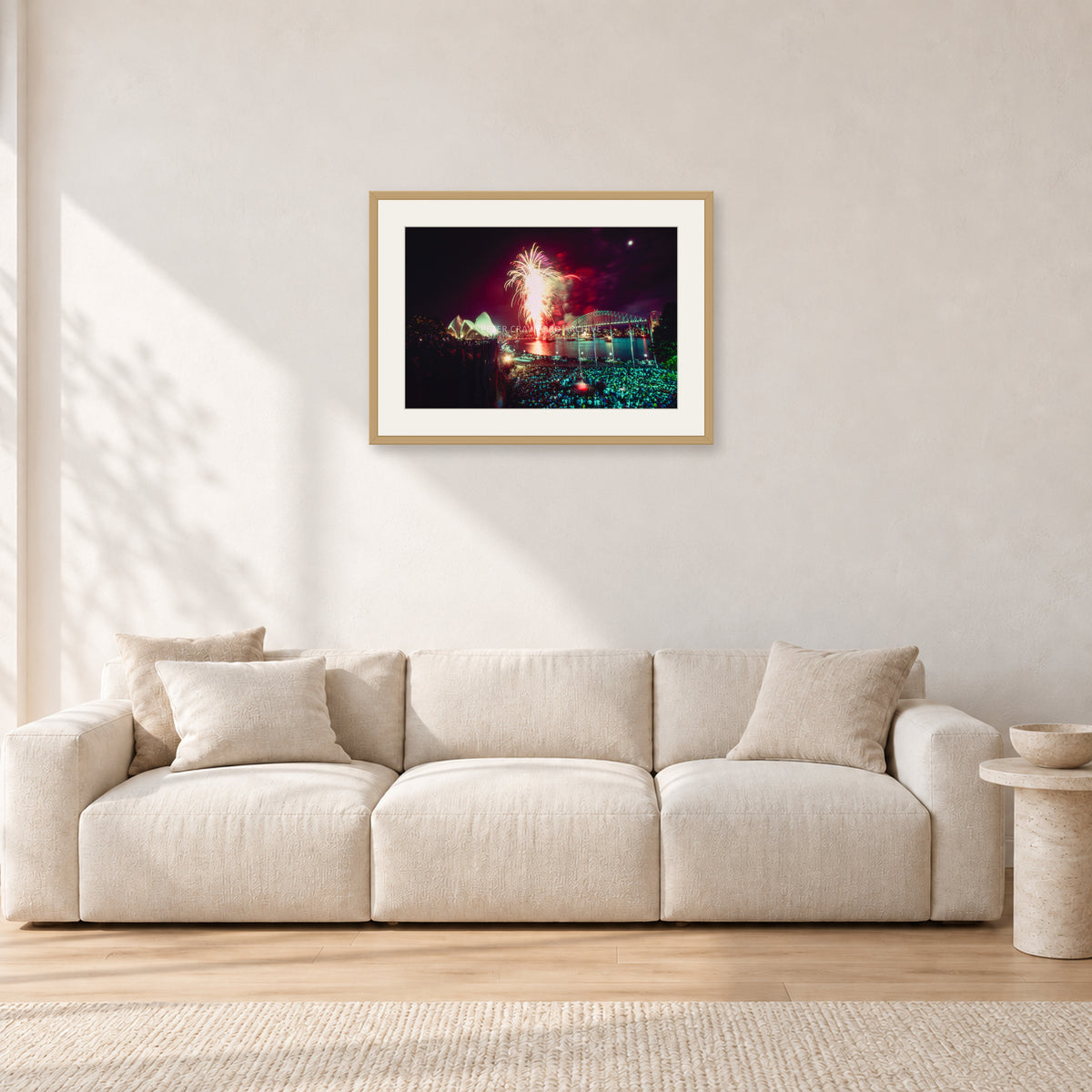 Tom Carroll and Aaron Chang, Waimea 1985 by Peter Crawford — 60 × 40 cm, hayseed frame with white mat, shown in a light minimalist living room.