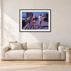 Tom Carroll, Mike Newling and Simon Anderson, Huntington 1984 by Peter Crawford — 90 × 60 cm, black frame with white mat, shown in a light minimalist living room.