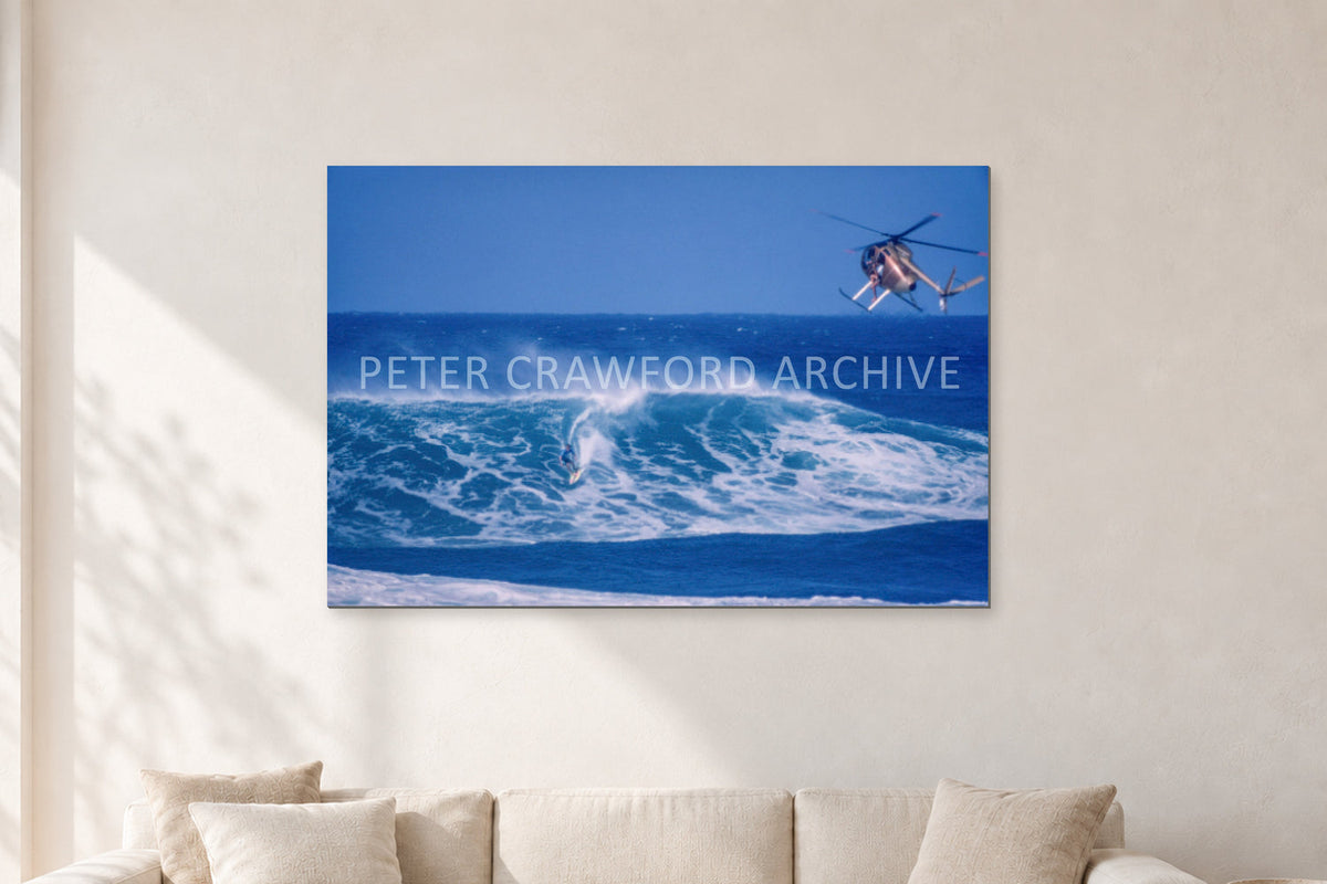 Tom Carroll, Sunset Beach Aerial by Peter Crawford — 120 × 80 cm, aluminium-mounted resin print, shown in a light minimalist living room.