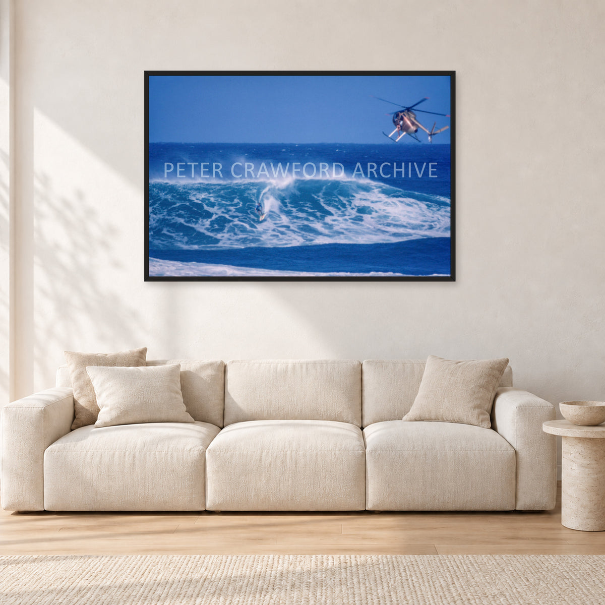 Tom Carroll, Sunset Beach Aerial by Peter Crawford — 120 × 80 cm, black frame, shown in a light minimalist living room.
