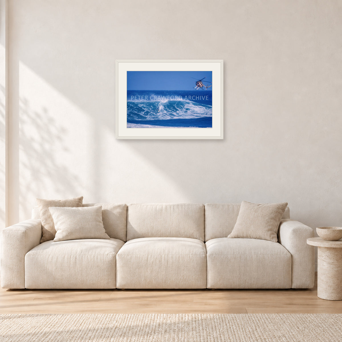 Tom Carroll, Sunset Beach Aerial by Peter Crawford — 60 × 40 cm, white frame with white mat, shown in a light minimalist living room.