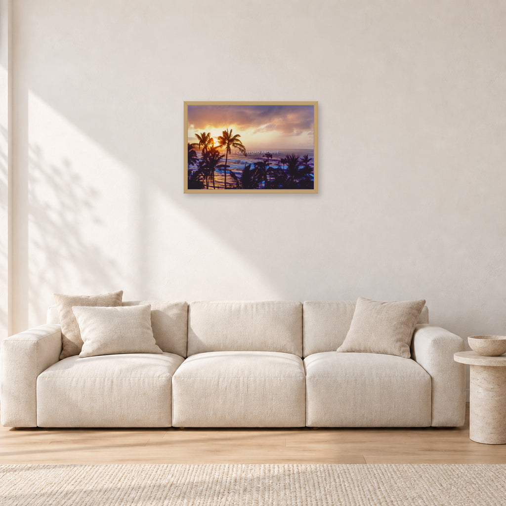 Turtle Bay Dusk by Peter Crawford — 60 × 40 cm, hayseed frame, shown in a light minimalist living room.