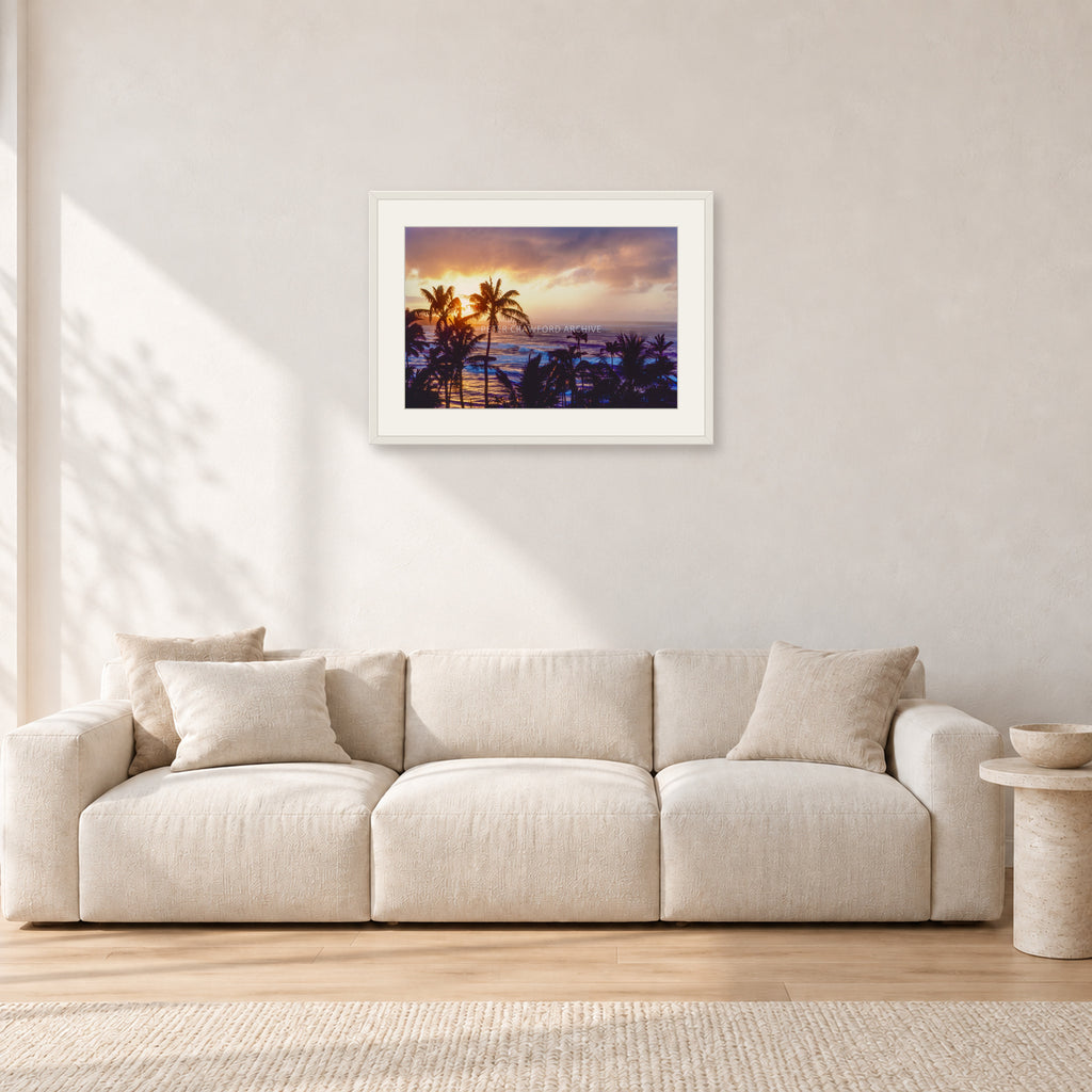 Turtle Bay Dusk by Peter Crawford — 60 × 40 cm, white frame with white mat, shown in a light minimalist living room.