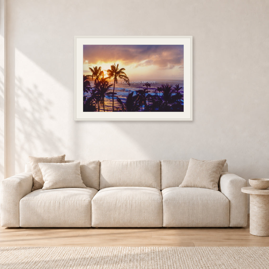 Turtle Bay Dusk by Peter Crawford — 90 × 60 cm, white frame with white mat, shown in a light minimalist living room.