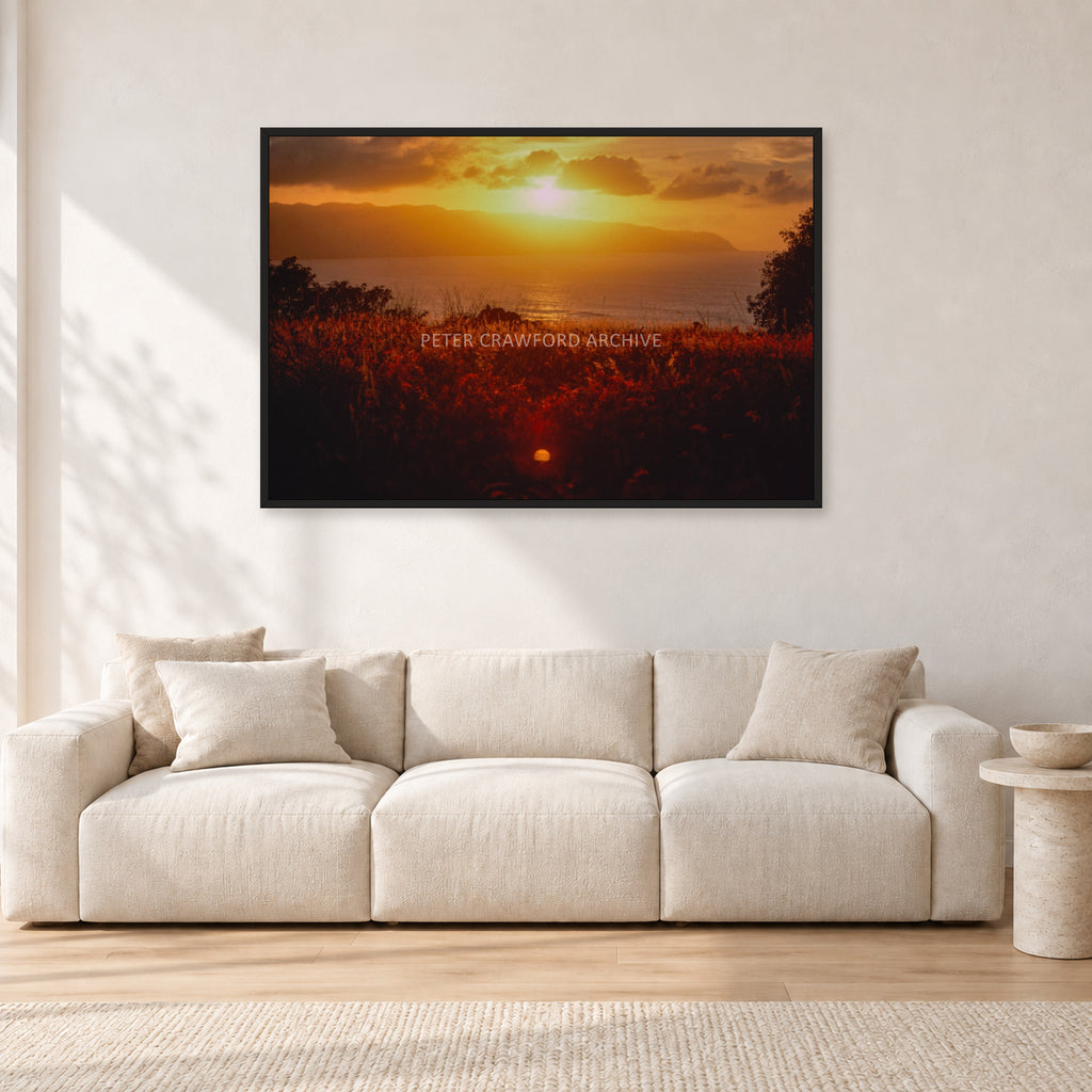 Waimea Dusk by Peter Crawford — 120 × 80 cm, black frame, shown in a light minimalist living room.