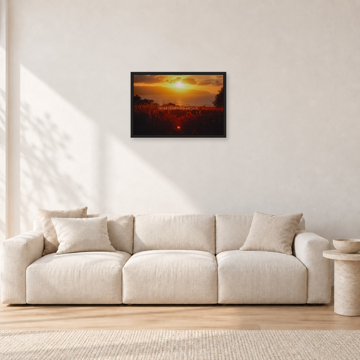 Waimea Dusk by Peter Crawford — 60 × 40 cm, black frame, shown in a light minimalist living room.