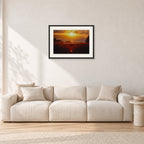 Waimea Dusk by Peter Crawford — 60 × 40 cm, black frame with white mat, shown in a light minimalist living room.