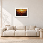 Waimea Dusk by Peter Crawford — 60 × 40 cm, white frame with white mat, shown in a light minimalist living room.