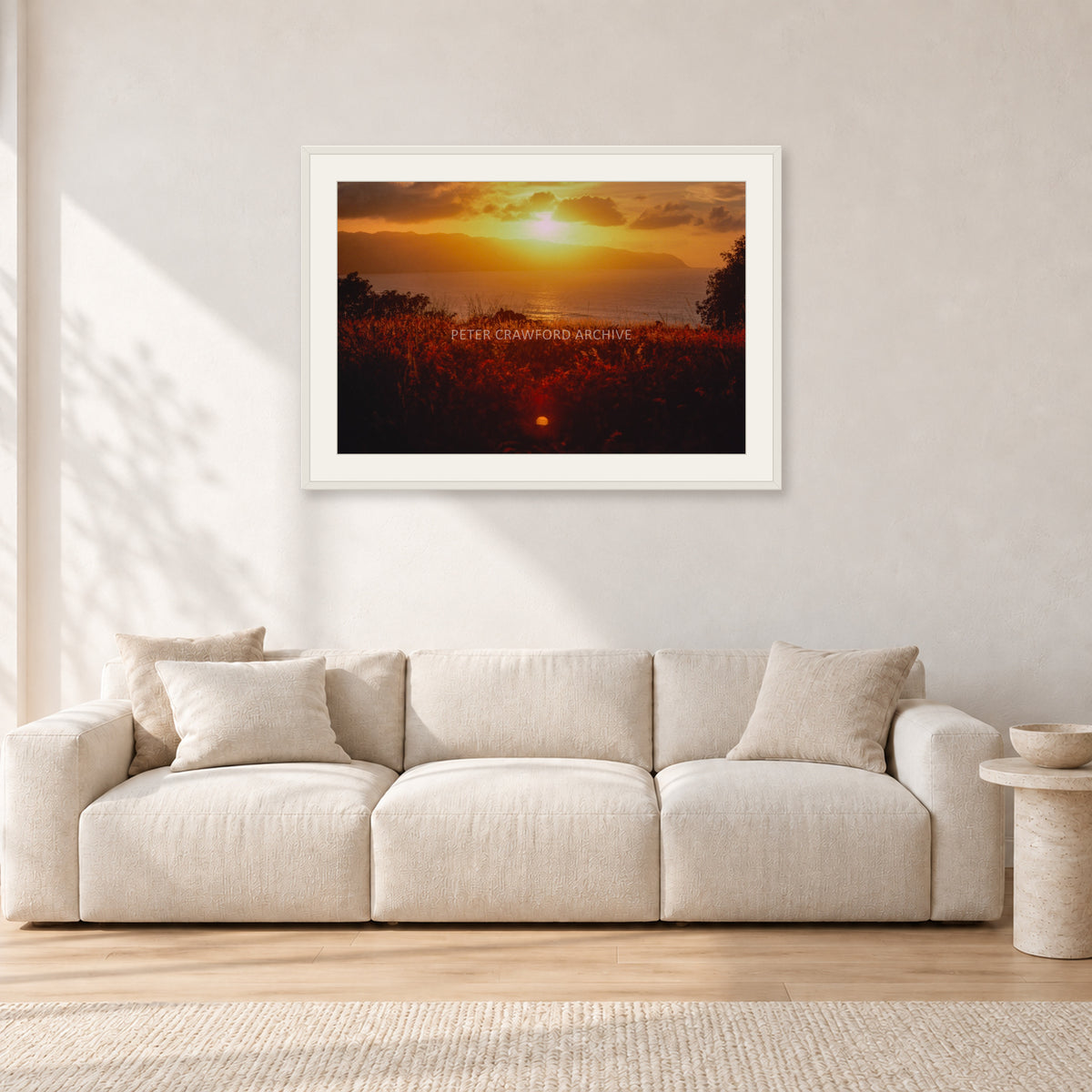 Waimea Dusk by Peter Crawford — 90 × 60 cm, white frame with white mat, shown in a light minimalist living room.