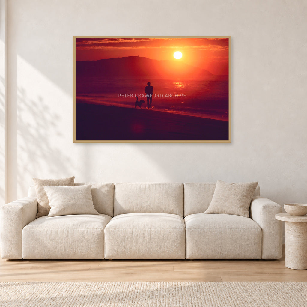 Winter Sun, Collaroy by Peter Crawford — 120 × 80 cm, hayseed frame, shown in a light minimalist living room.