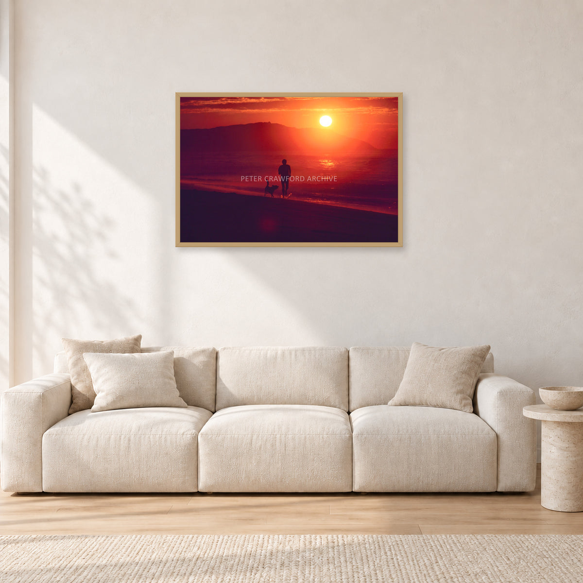 Winter Sun, Collaroy by Peter Crawford — 90 × 60 cm, hayseed frame, shown in a light minimalist living room.